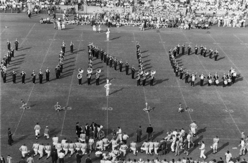 Marching band on football field in the form of the letters U, N, and C