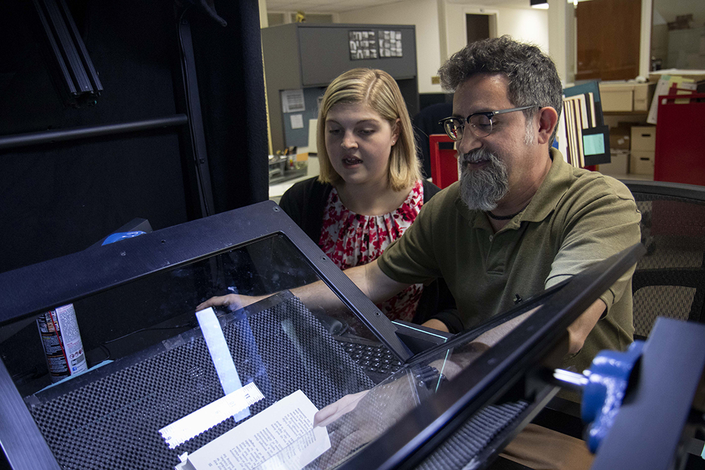 Library staff digitizing books