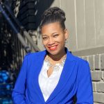 Sarita Alston posing for a portrait in a blue jacket