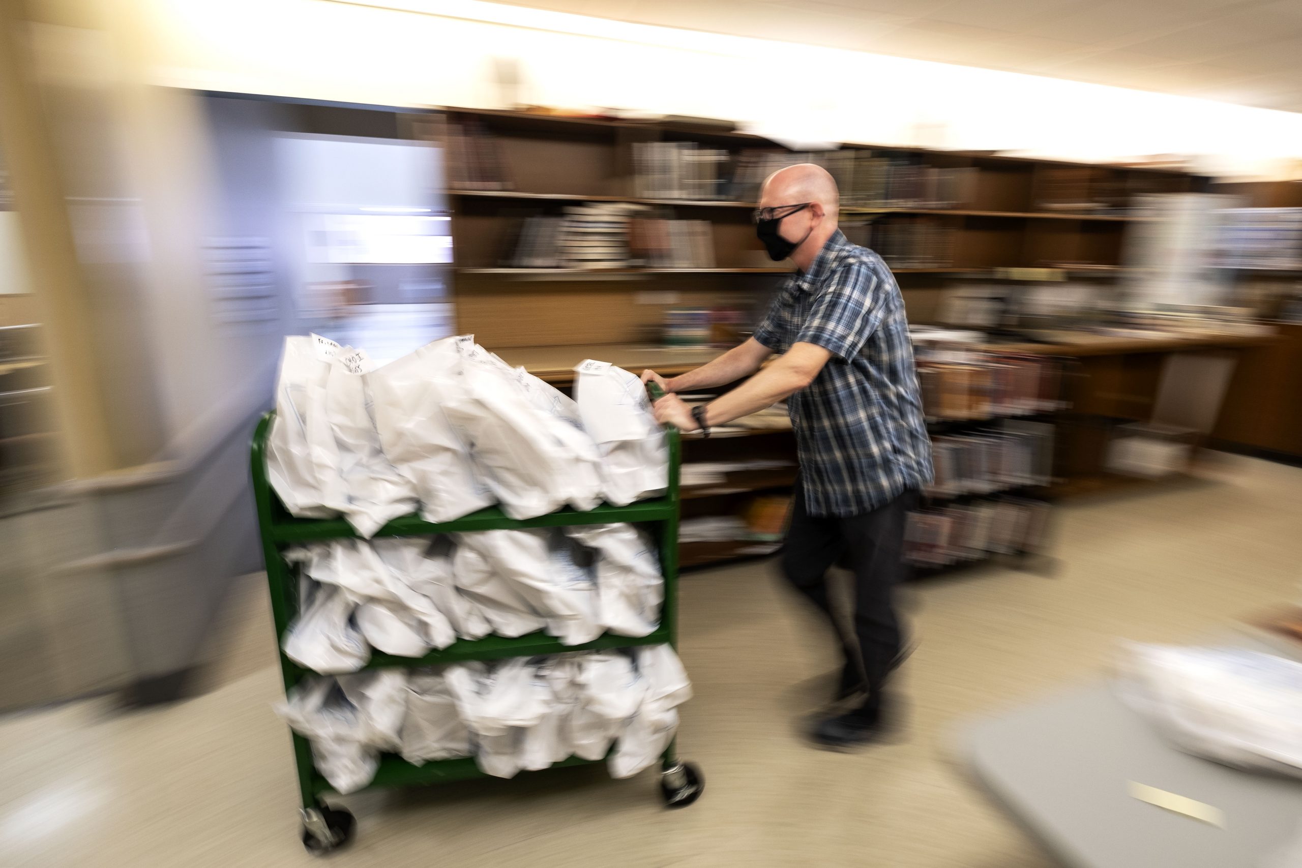 Joe Mitchem, Assistant Head of Davis Library Circulation, readies books for curbside pick-up.