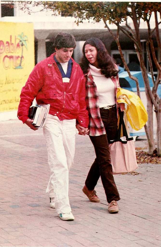 Two students holding hands walking in front of the Carolina Union, 1990. 