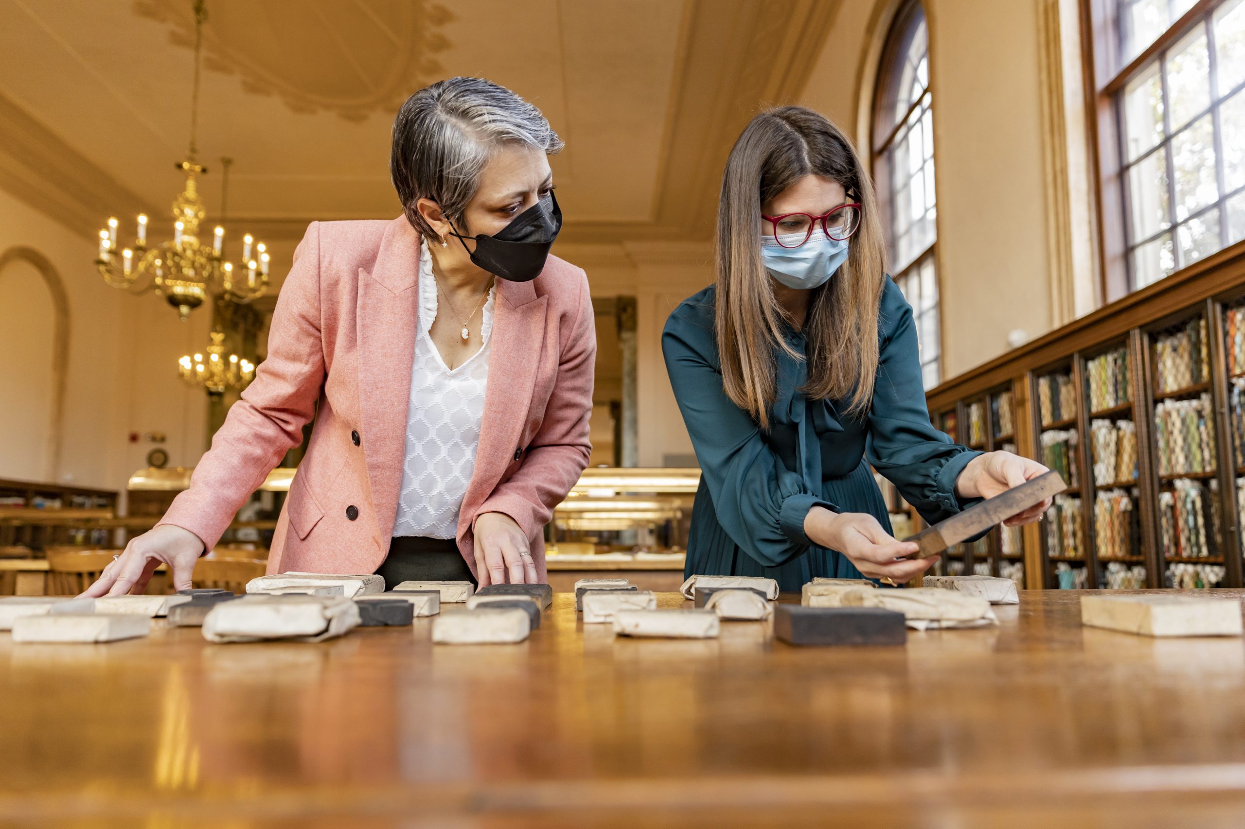 Maria Estorino and Liz Ott inspect blocks from the 9 millionth volume, a set of 900 woodcut printing blocks
