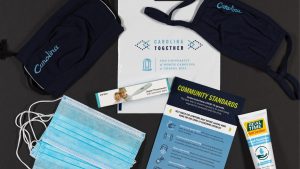 Carolina Together COVID19 toolkit featuring informational handout, hand sanitizer, thermometer, and face masks