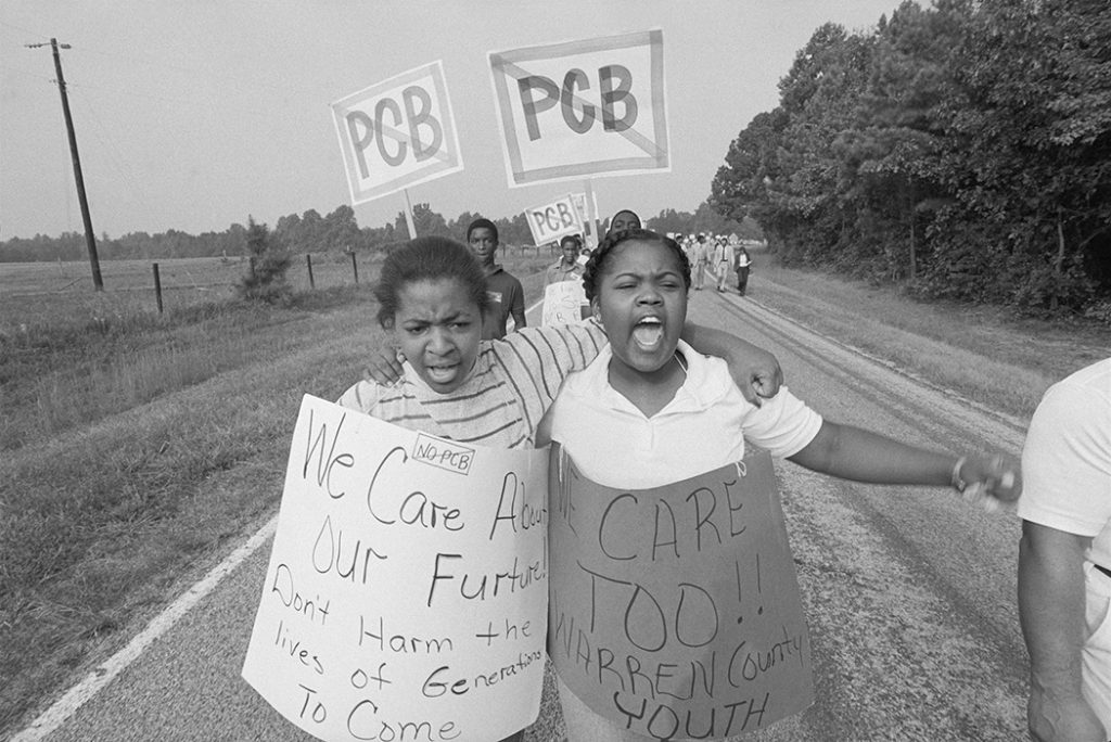 Wanda Andrews Saunders and Consherto Williams march with signs during the PCB protests.