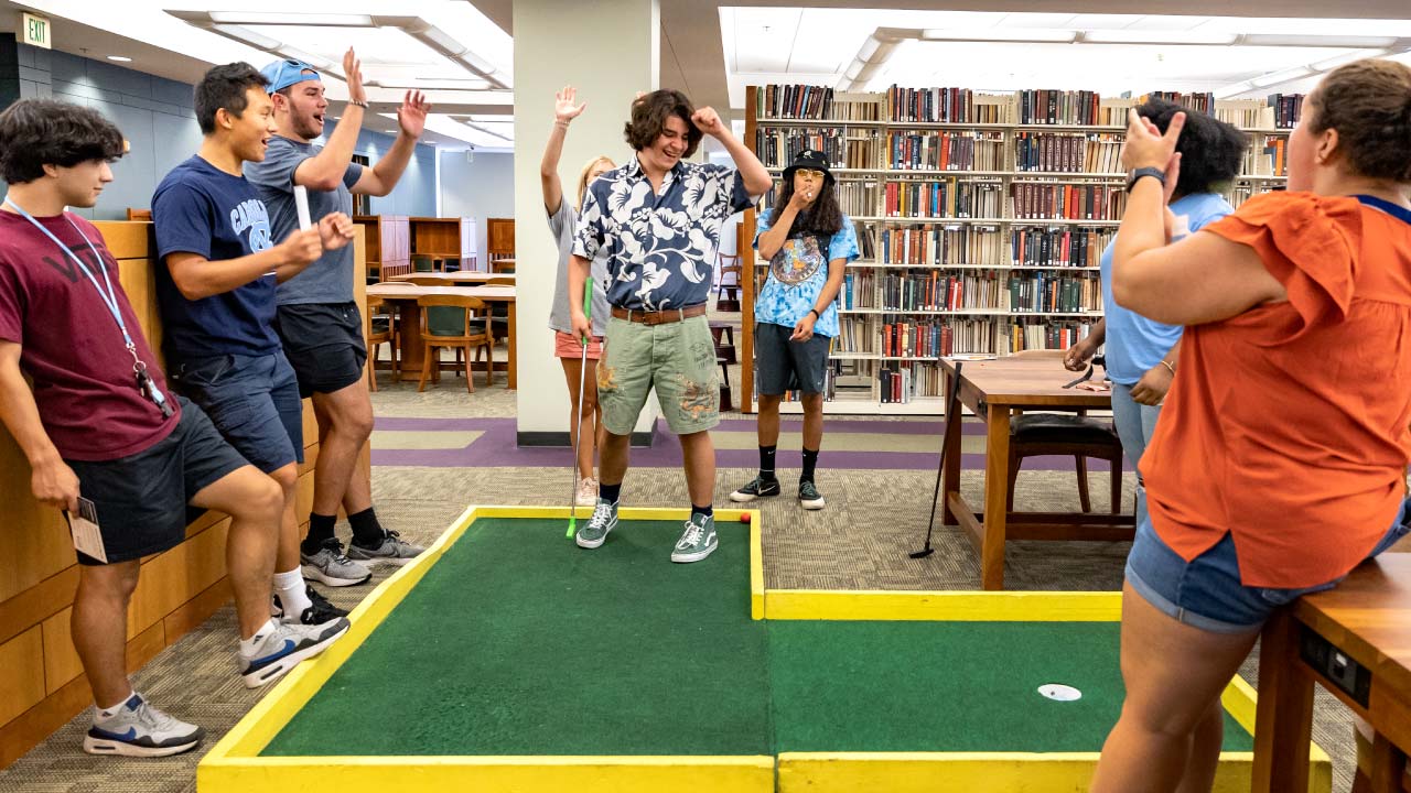 students playing mini golf in the library