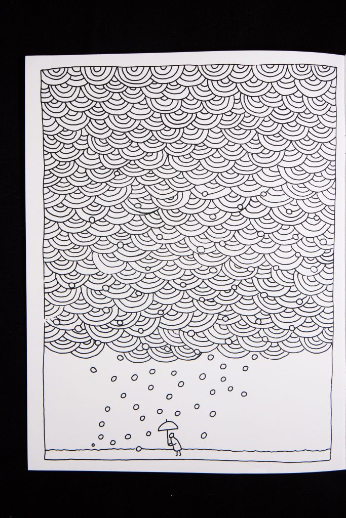 Black and white page from a coloring book showing intricate line are and a small stick figure at the bottom holding an umbrella