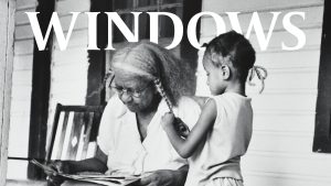Windows text with a black and white photograph of an elderly woman and young child braiding hair on the front porch of a house