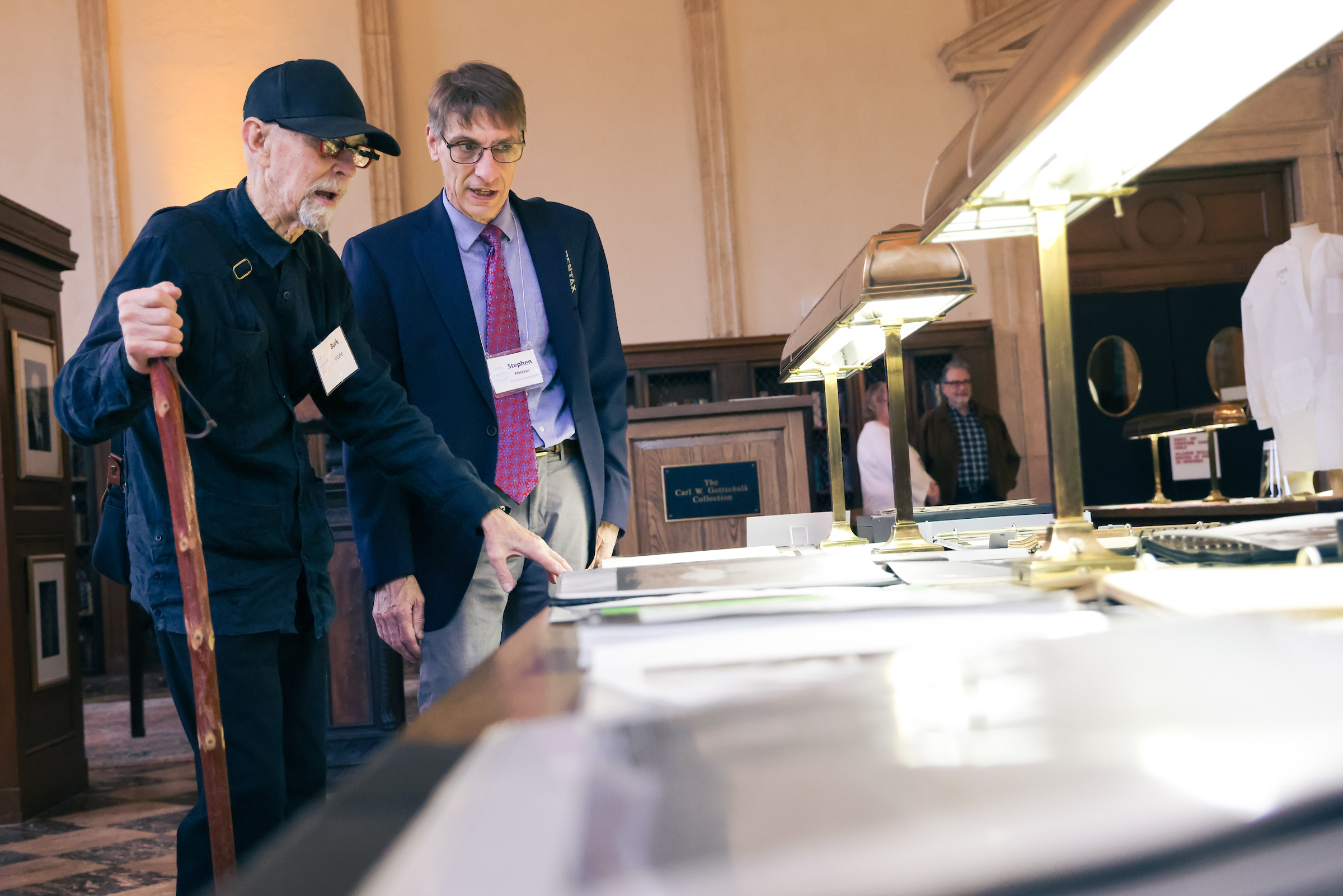 Burke Uzzle and Stephen Fletcher look at Uzzle's photographic collection in the Fearrington Reading Room during Recent Acquisitions Evening