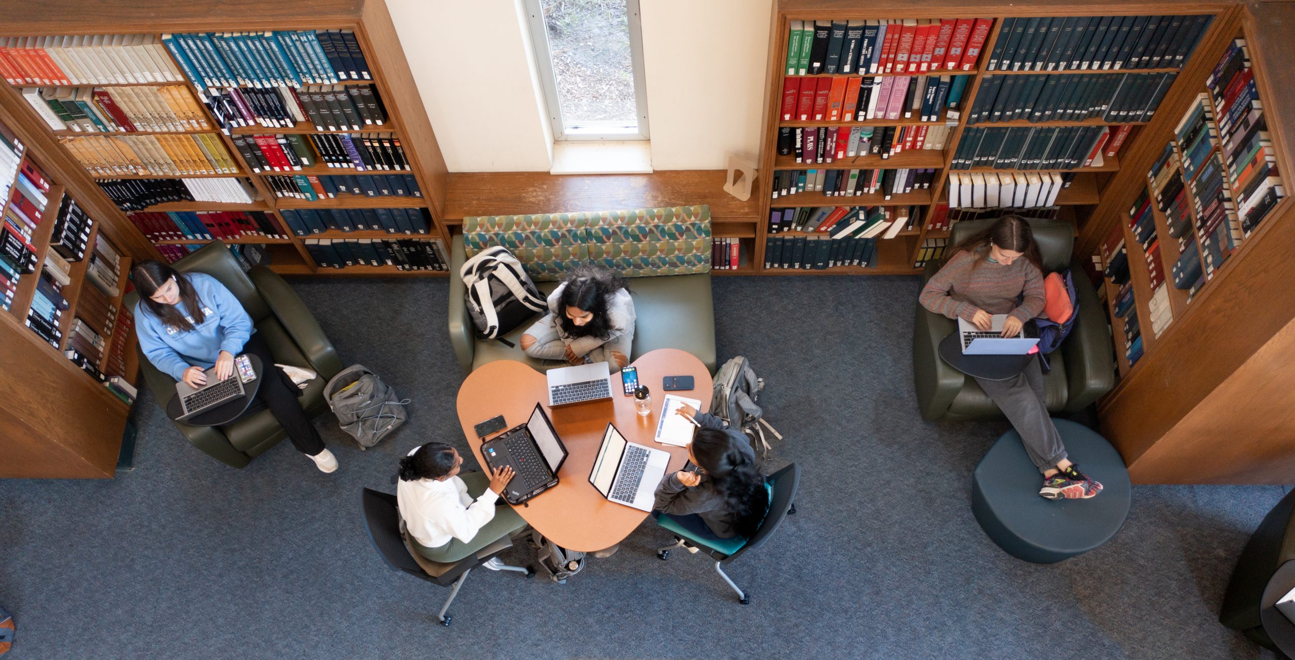 students studying at a shared desk in Davis Library