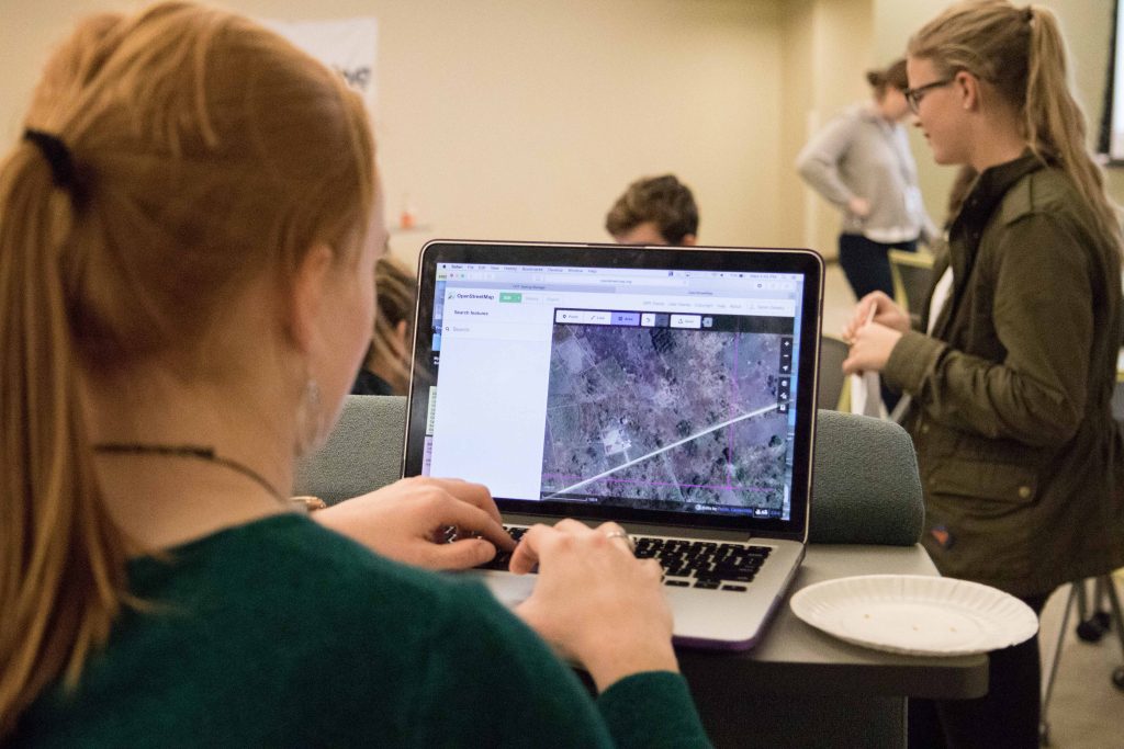 student working with GIS software on laptop