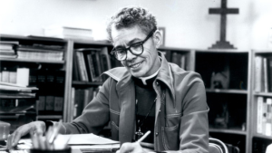 Pauli Murray sits at a desk and writes.
