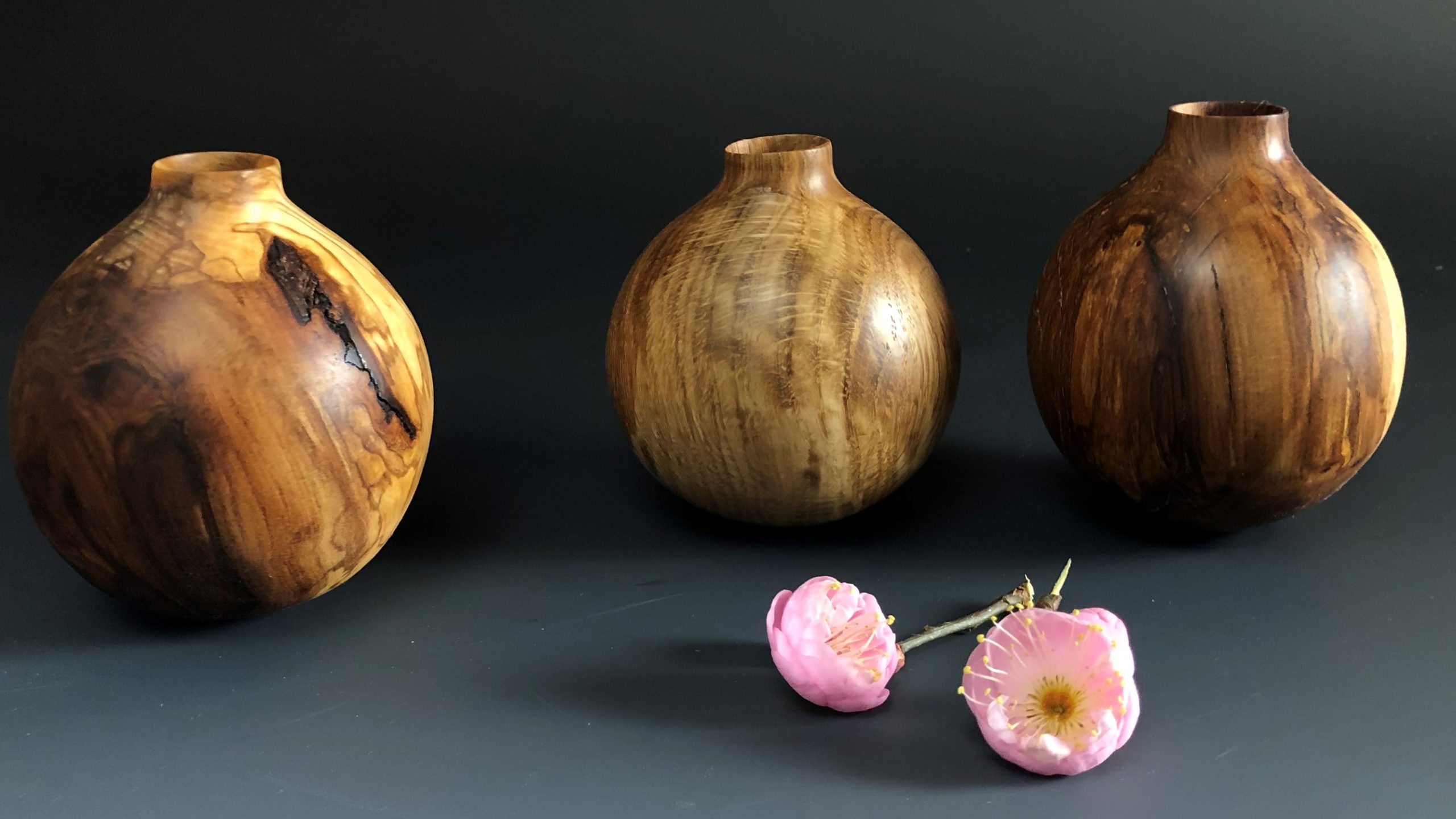 Three carved wooden vases.